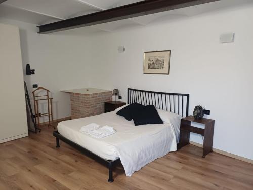 a bedroom with a bed with white sheets on it at Da Ciro e Angela in Barolo