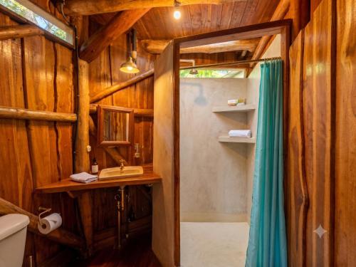 a bathroom with a shower and a sink at Don Jon's Surf and Yoga Lodge in Santa Teresa Beach