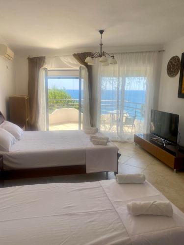 a bedroom with two beds and a view of the ocean at TALi in Ulcinj