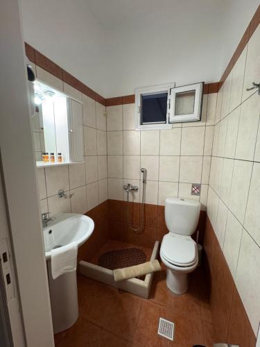 a small bathroom with a toilet and a sink at Dream Catcher3 in Agia Theodoti