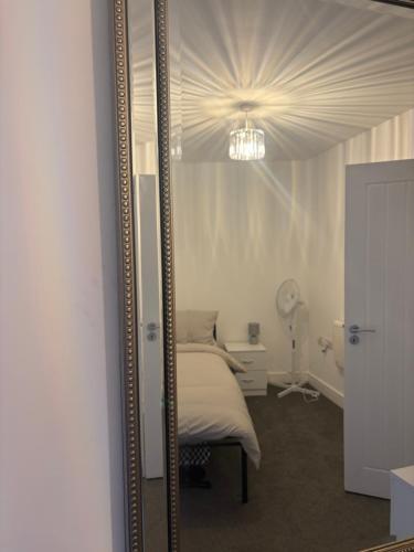 a large mirror in a room with a bed at Pork pie pad in Melton Mowbray