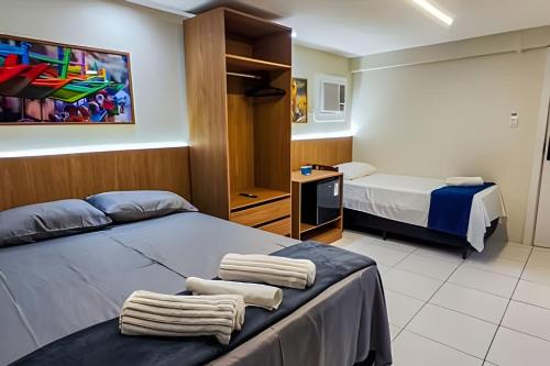 a hotel room with two beds with towels on the bed at Refúgio da Praça: Charme e Conforto in Belém