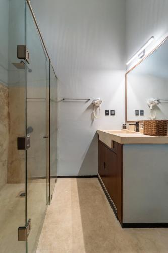 a bathroom with a shower and a sink and a mirror at Casa Balada Santa Lucía with Parking by Cercana in Mérida