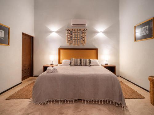 a bedroom with a large bed with two night stands at Casa Balada Santa Lucía with Parking by Cercana in Mérida