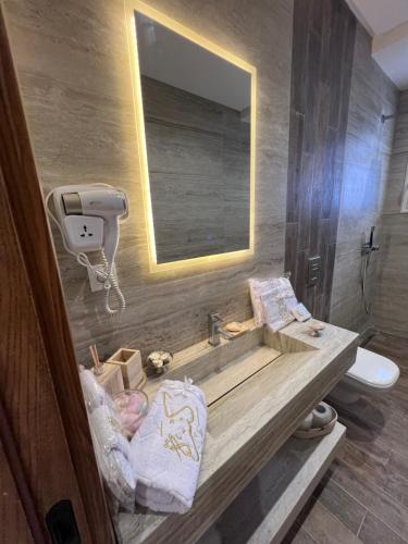 a bathroom with a sink and a mirror at Résidences kenza in Kelibia