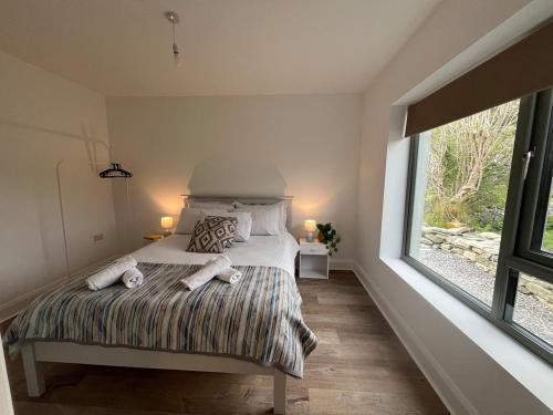 a bedroom with a bed with two towels on it at Little Hills in Westport