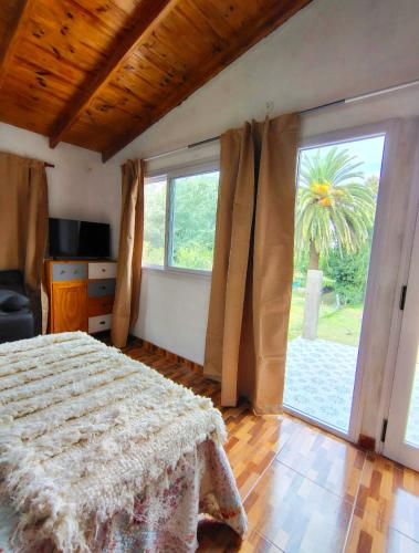 a bedroom with a bed and a large window at La Elegida Villars in General Las Heras