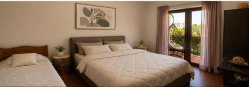 a bedroom with a large bed and a balcony at Seaside Apartments - Vasilije in Baošići