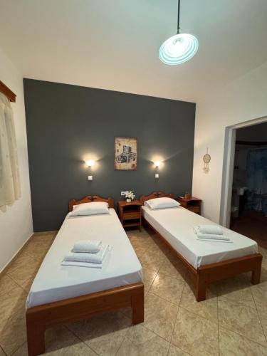 a bedroom with two beds and a blue wall at Dream catcher 1 in Agia Theodoti