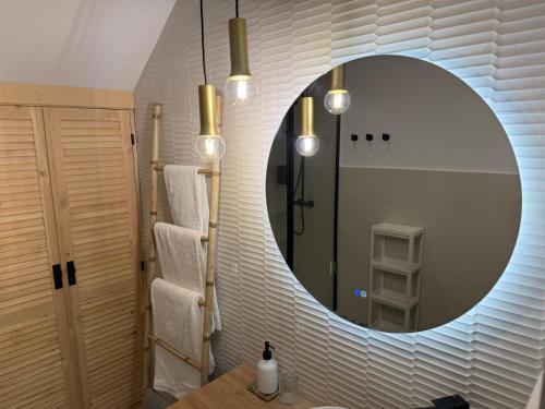 a bathroom with a round mirror and a sink at Apartamento Casa Nela 3 in Medellín