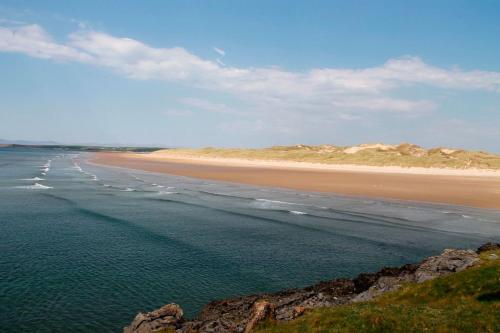 a view of a beach with sand dunes in the distance at Atlantic Point Stunning Sea View in Bundoran