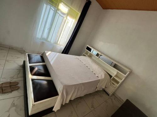 an empty bed in a room with a window at Blue Home Stay in Janjagiro