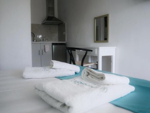 a room with white towels on a table at Poseidon Complex in Paleokastritsa