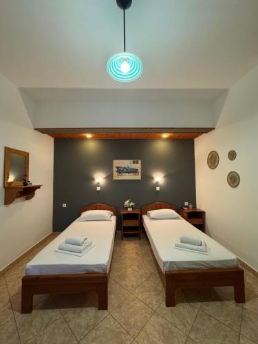 a bedroom with two beds and a blue light at Dream catcher 4 in Ios Chora