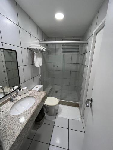 a bathroom with a toilet and a sink and a shower at Gran Lençóis Flat Residence Barreirinhas in Barreirinhas