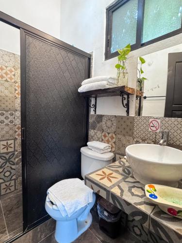 a bathroom with a sink and a toilet at Casa Aluxes Hotel in Valladolid