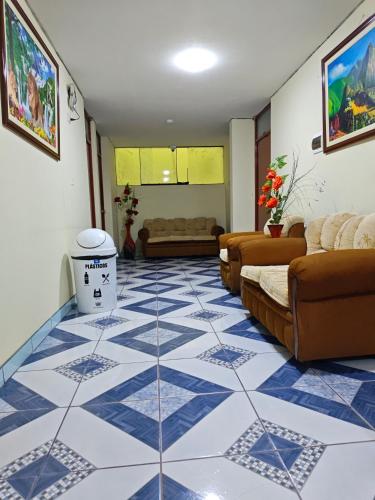 a living room with a blue and white tiled floor at Hostal Amazonas in Chivay