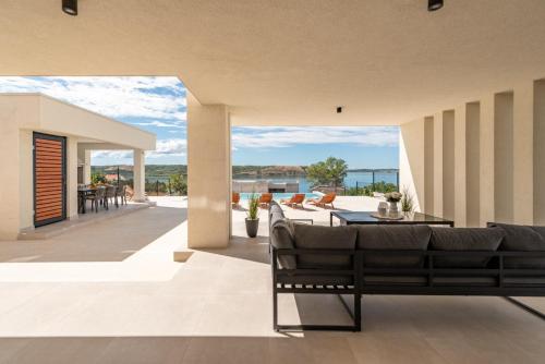 a living room with a couch and a table at Villa Infinity in Rtina