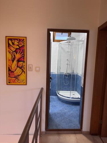 a hallway with a glass door leading to a bathroom at Villa Bella Sozopol in Sozopol