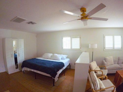 a bedroom with a bed and a ceiling fan at Quail's Nest - Downtown Studio in Tucson