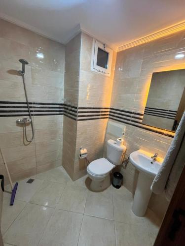 a bathroom with a toilet and a sink at Baya Residentie in Temara