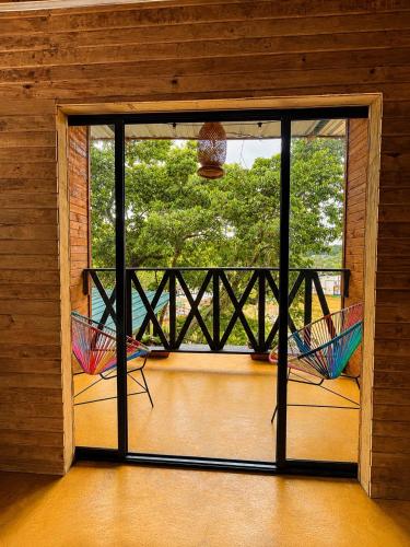 two colorful umbrellas on a balcony with a window at Coffee House Minca in Minca