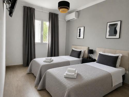 a bedroom with two beds and a window at Pool&River Villa in Alcoutim