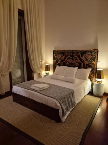 a bedroom with a large bed with two lamps at Alto Belo in Felgueiras