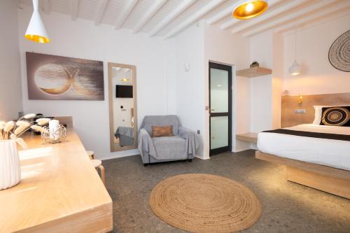 a bedroom with a bed and a desk and a chair at Double M Adults Only in Ano Mera