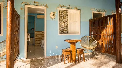 a room with a table and chairs and a door at Pousada Universo Arraial in Arraial d'Ajuda