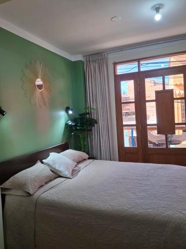 a bedroom with a large bed and a window at Balneario del Inca in Los Baños del Inca
