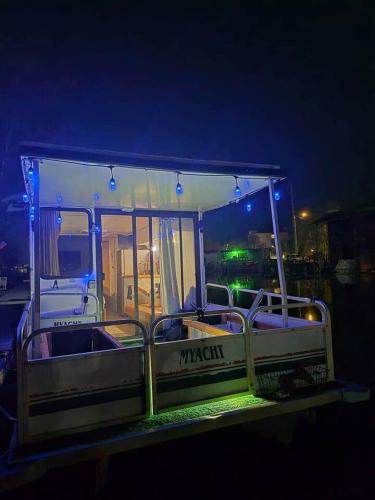 a boat is docked in the water at night at Knot Work Cayuga Lake 30ft Boat in Ithaca