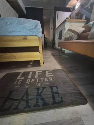a bedroom with a bed and a rug on the floor at Knot Work Cayuga Lake 30ft Boat in Ithaca