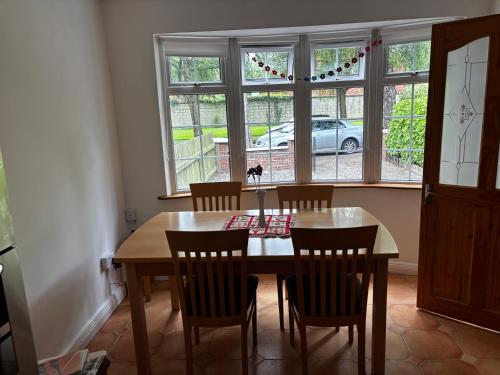 a dining room with a table and chairs and a window at Dublin 12 house in Dublin