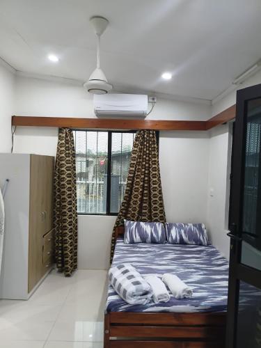 a room with a bed in a room at Cozy Self-contained Unit in Lautoka