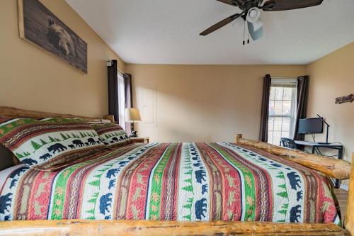 a bedroom with a large bed and a ceiling fan at Heavenly View - Bear Themed Cabin, HotTub, Dog-Friendly, Near Gatlinburg in Gatlinburg