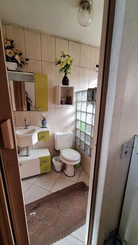 a small bathroom with a toilet and a sink at Sítio do piu in Lombas