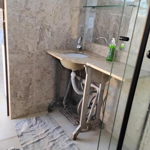 a bathroom with a sink and a shower at Cantinho da Lobeira in Alto Paraíso de Goiás