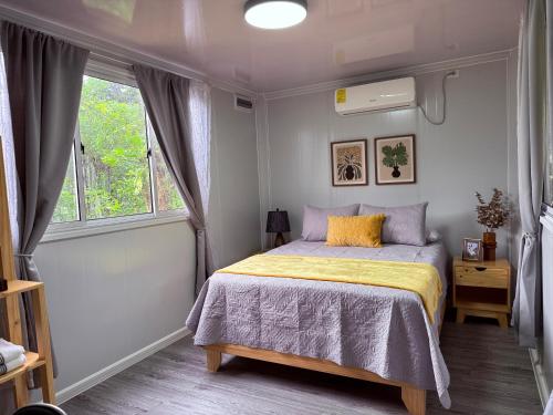 a bedroom with a bed and a window at Río Celeste Stay in Rio Celeste