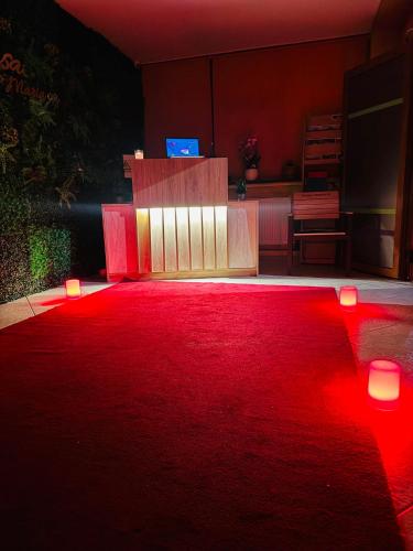 a room with a red carpet and red lights at Vila Rosa Maria in Mangalia