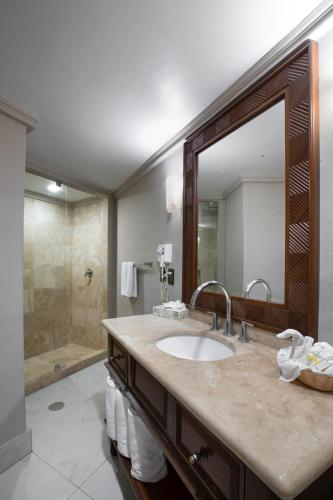 a bathroom with a sink and a large mirror at Royal Villas Resort in Mazatlán
