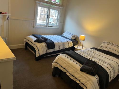 a bedroom with two beds and a window at Armidale Central Guest House in Armidale