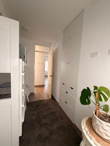 a room with white cabinets and a potted plant at Punta Hermosa Apartment in Punta Hermosa