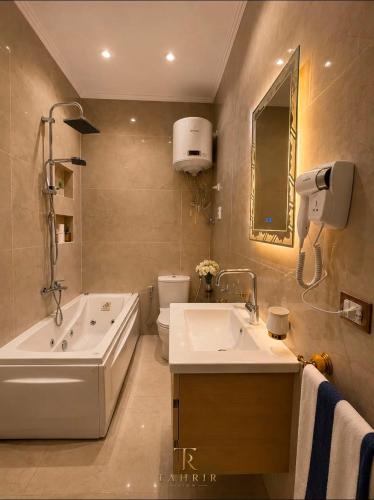 a bathroom with a tub and a sink and a toilet at Lumina View Hotel by Tahrir - Downtown in Cairo