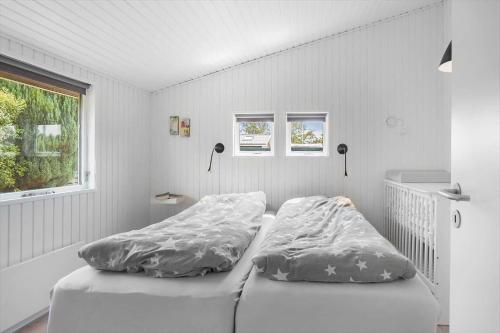 a bedroom with two beds and a window at FY147-Middelfart-Antaresvej-6 in Middelfart
