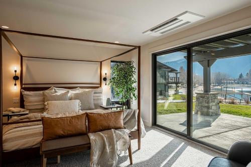 a bedroom with a bed and a sliding glass door at Designer Lakefront Condo C1 Wapato Point Chelan in Manson