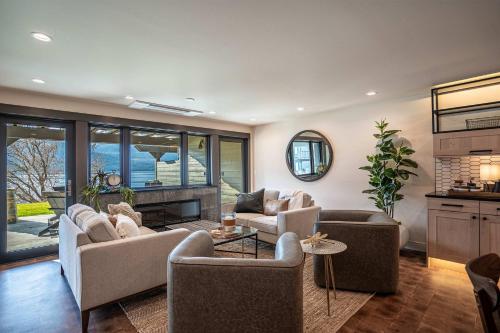 a living room with couches and a fireplace at Designer Lakefront Condo C1 Wapato Point Chelan in Manson