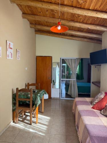 a living room with two beds and a table at Cabañas Las Marias in San Luis