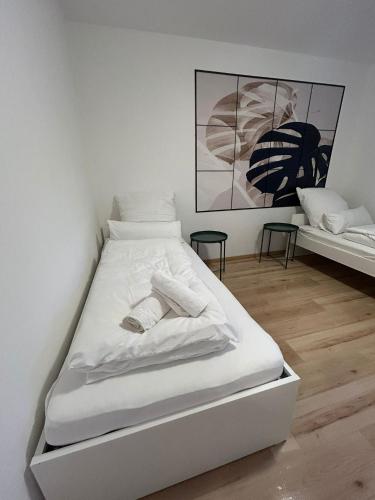 a white bed with two pillows on it in a room at Monteurs Freund in Lotte