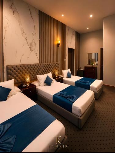 a hotel room with three beds and a map on the wall at Lumina View Hotel by Tahrir - Downtown in Cairo